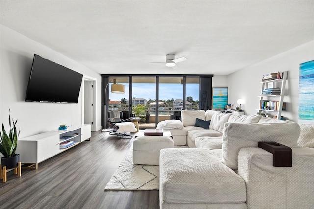 living room with ceiling fan, expansive windows, and dark hardwood / wood-style flooring