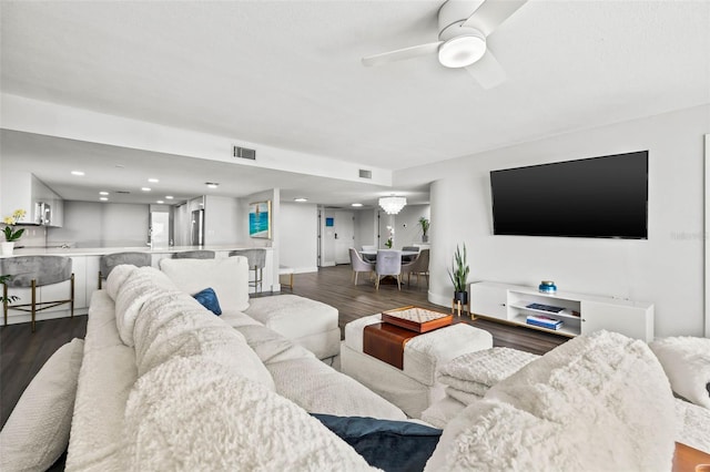 living room with dark hardwood / wood-style flooring and ceiling fan