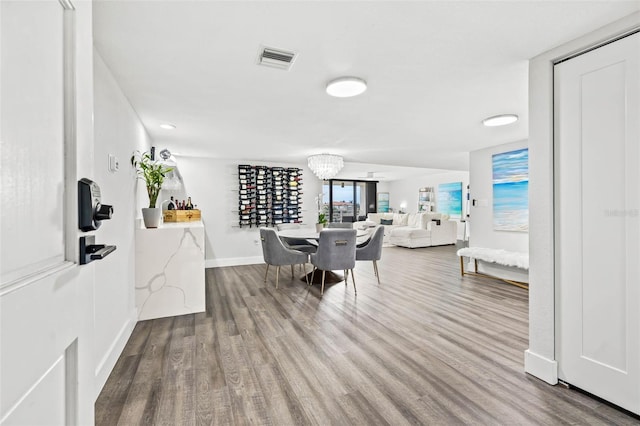 dining area with a chandelier and hardwood / wood-style flooring