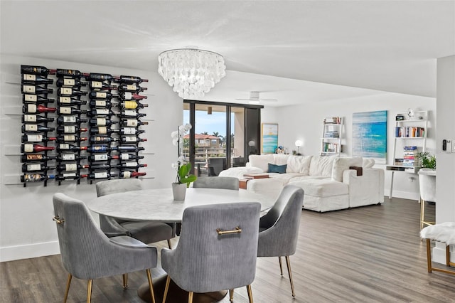 dining room with a notable chandelier and hardwood / wood-style flooring