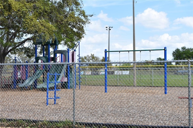 view of home's community with fence and playground community