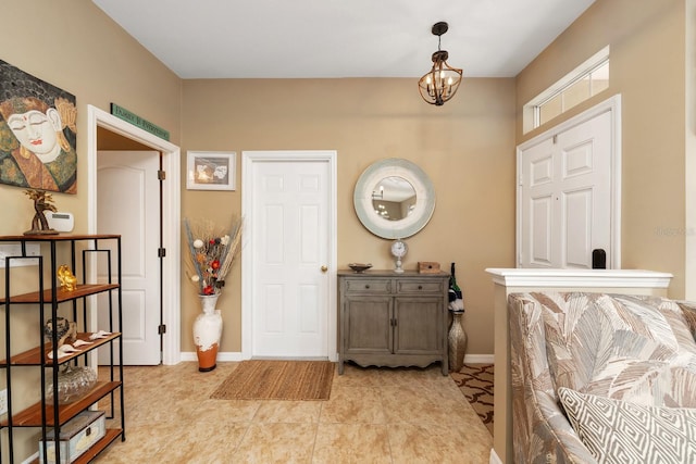 tiled foyer entrance featuring a chandelier