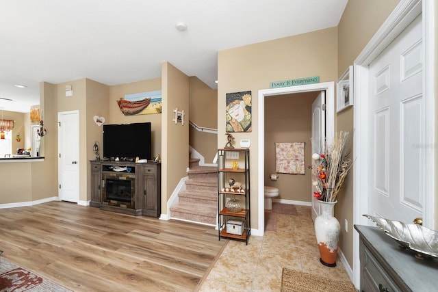 foyer entrance with a fireplace and light hardwood / wood-style flooring