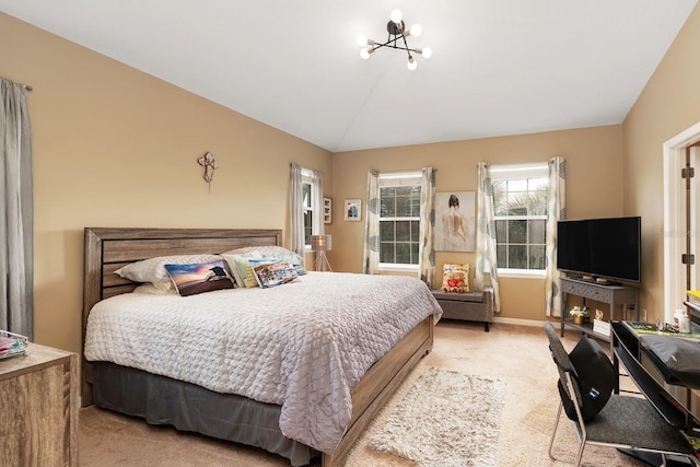 carpeted bedroom featuring lofted ceiling and an inviting chandelier