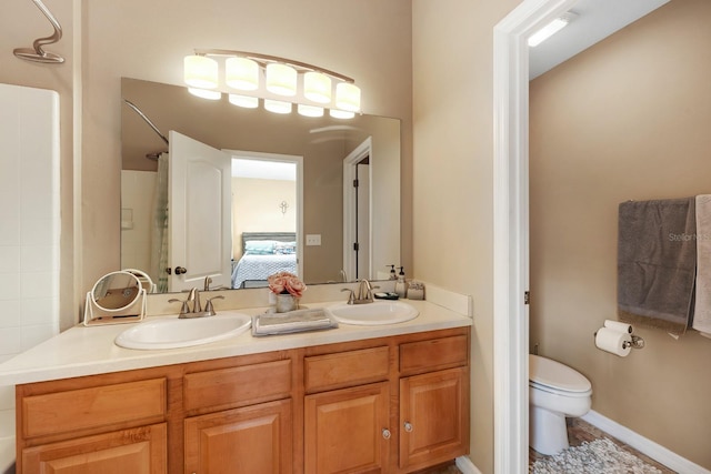 bathroom with a shower, vanity, and toilet