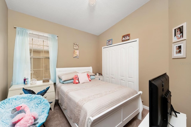 bedroom with a closet, carpet floors, and vaulted ceiling