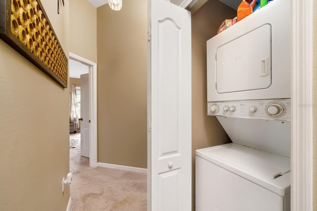 clothes washing area featuring light colored carpet and stacked washer / dryer