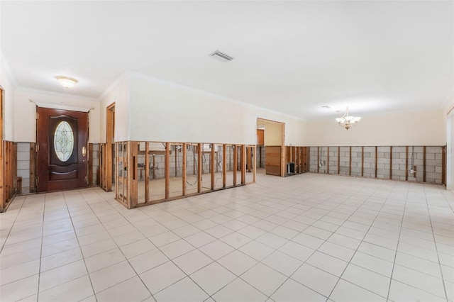 interior space featuring crown molding, light tile patterned floors, and a notable chandelier