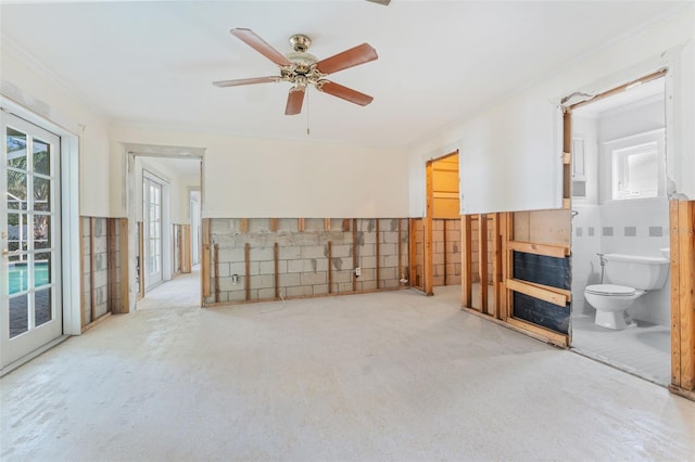 living room featuring tile walls and ceiling fan