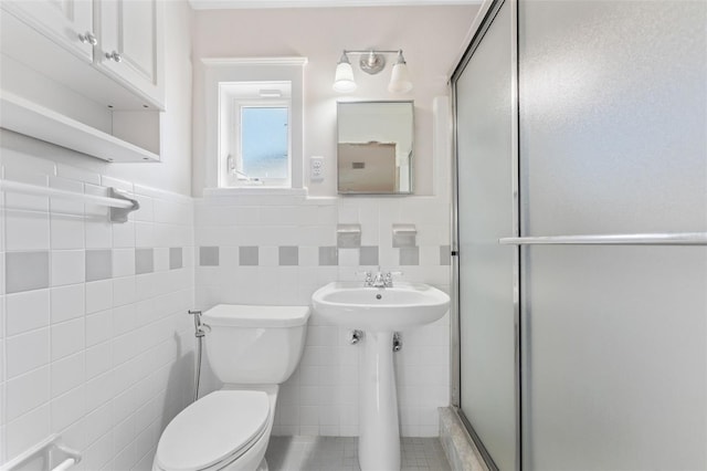 bathroom featuring sink, tile walls, tile patterned flooring, toilet, and walk in shower