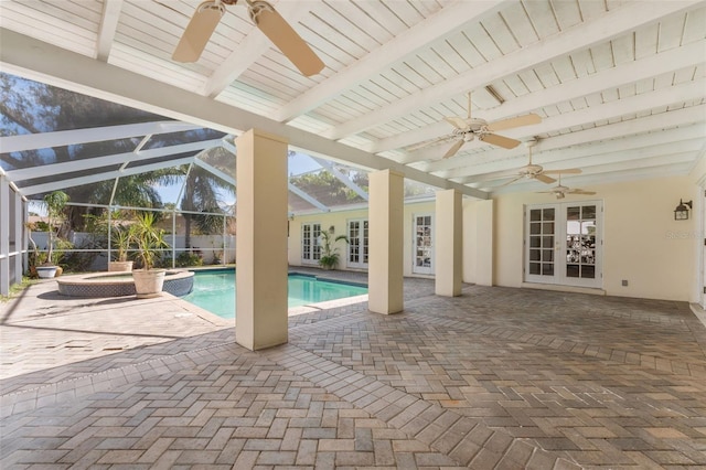 view of swimming pool featuring french doors, ceiling fan, glass enclosure, and a patio area