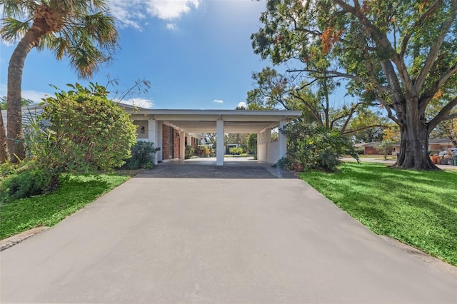 exterior space featuring a front yard and a carport