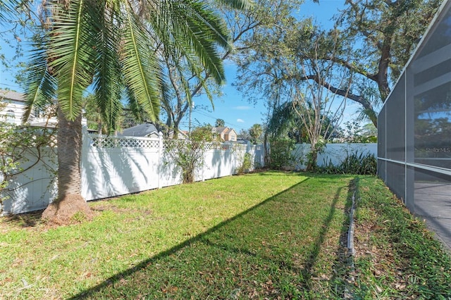 view of yard featuring glass enclosure