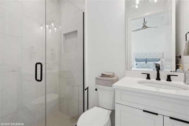 bathroom featuring vanity, toilet, and a shower with shower door