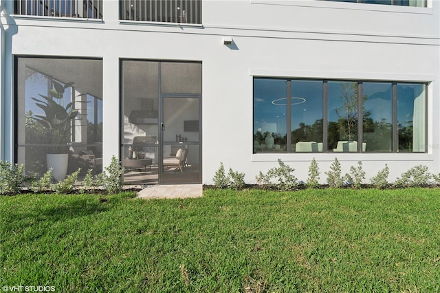 exterior space with a lawn and a sunroom