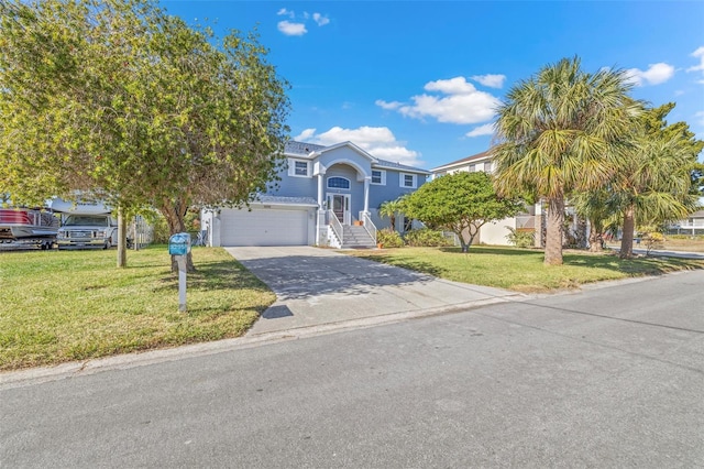 view of front of home featuring a front yard and a garage