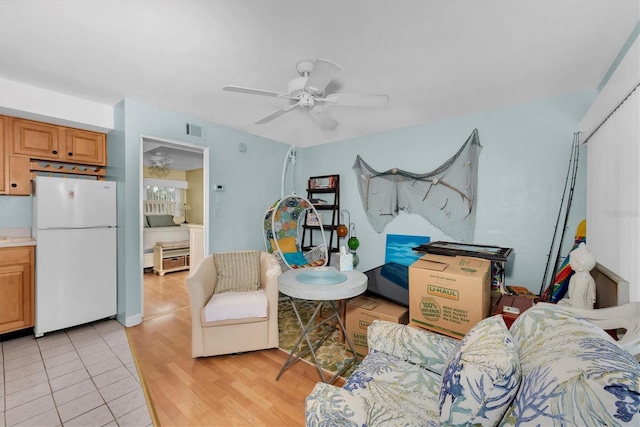 living room with ceiling fan and light wood-type flooring