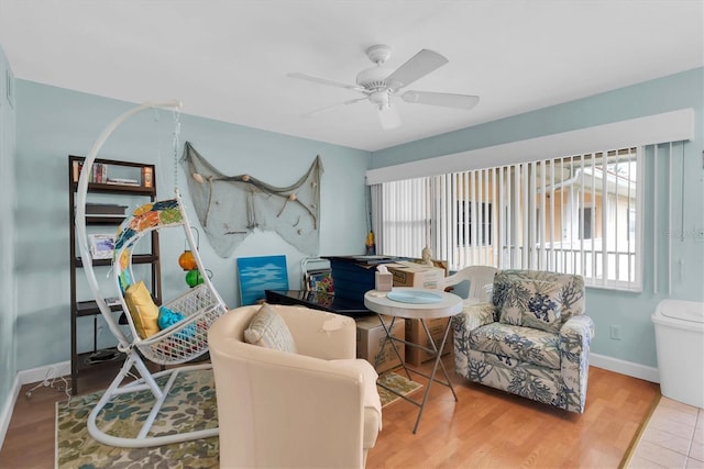 living room featuring wood-type flooring, plenty of natural light, and ceiling fan