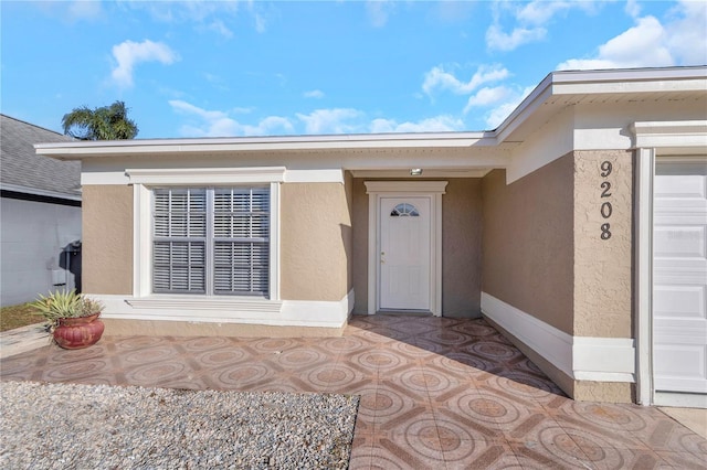 view of exterior entry with a garage