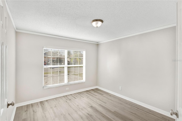 unfurnished room featuring crown molding, light hardwood / wood-style flooring, and a textured ceiling