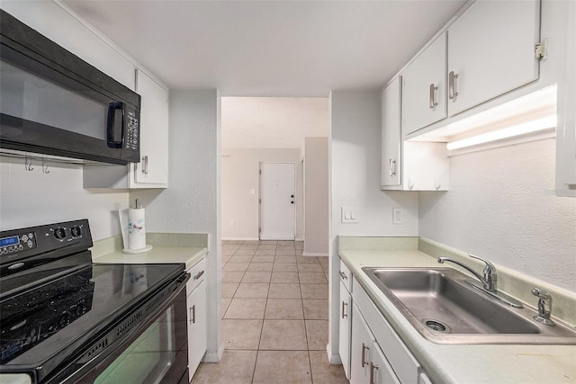 kitchen with black appliances, light tile patterned flooring, white cabinetry, and sink