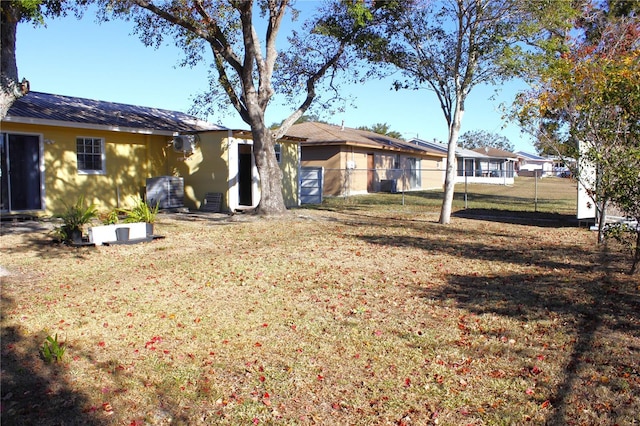 rear view of house featuring a lawn