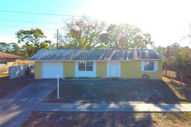 12663 Eddington Rd, Spring Hill, FL 34609 - ranch-style house featuring a garage, metal roof, and driveway