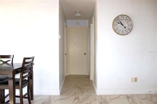 hallway featuring a textured ceiling