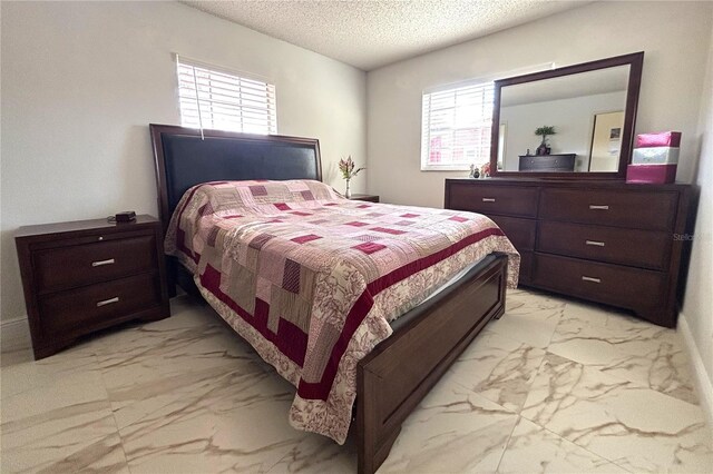 12663 Eddington Rd, Spring Hill, FL 34609 - bedroom featuring light marble finish flooring, a textured ceiling, and multiple windows