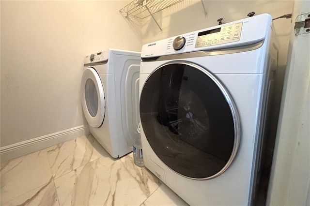 12663 Eddington Rd, Spring Hill, FL 34609 - laundry area featuring light marble finish flooring and baseboards