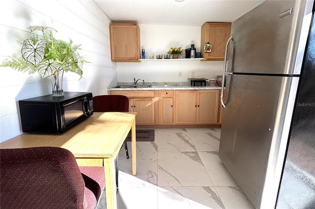 kitchen featuring sink and stainless steel refrigerator