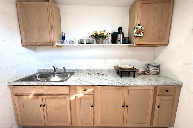 bar featuring light brown cabinets and sink