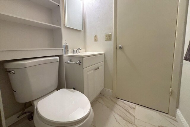 12663 Eddington Rd, Spring Hill, FL 34609 - bathroom featuring marble look tiles, vanity, toilet, and baseboards