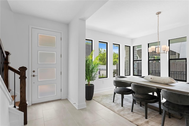 dining room featuring light tile patterned flooring and an inviting chandelier