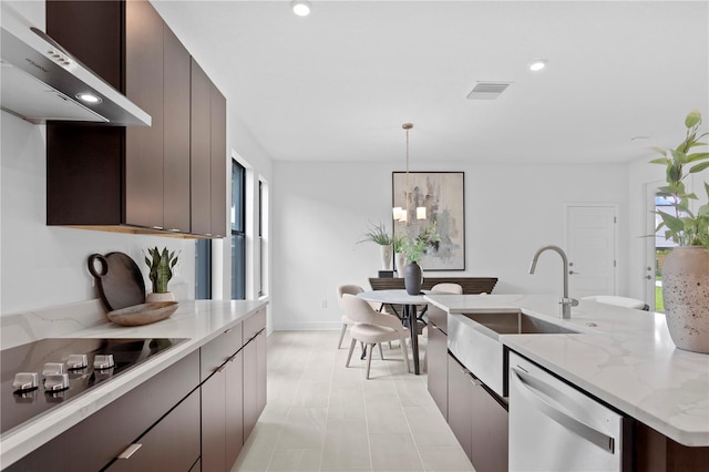 kitchen with black electric stovetop, stainless steel dishwasher, a kitchen island with sink, wall chimney range hood, and decorative light fixtures