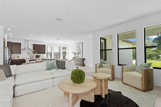 living area featuring recessed lighting, a healthy amount of sunlight, and visible vents