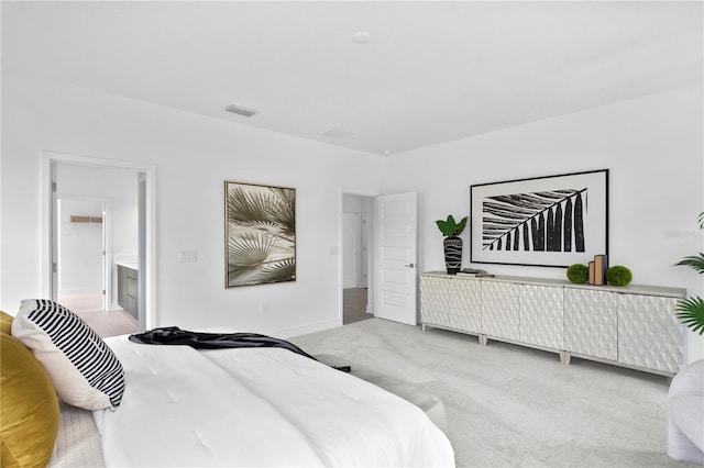 bedroom with light carpet, connected bathroom, and baseboards