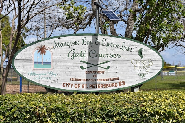 community / neighborhood sign featuring fence