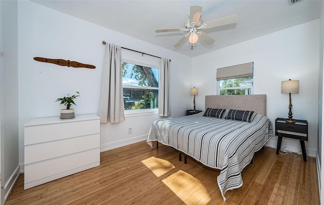 bedroom with ceiling fan and hardwood / wood-style floors