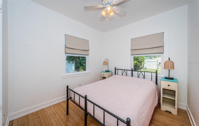 bedroom with wood-type flooring and ceiling fan