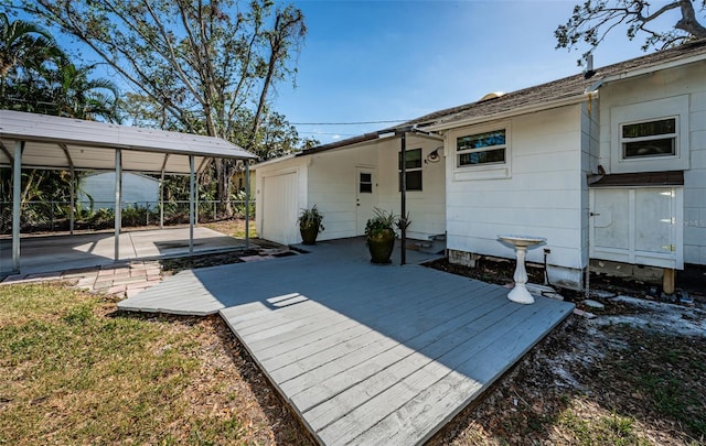 rear view of property featuring a deck and a carport