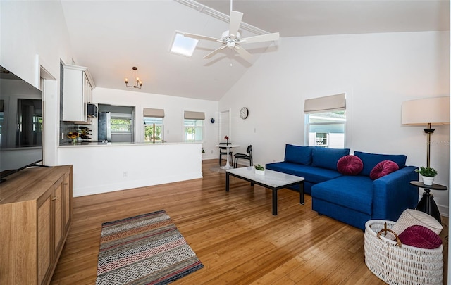 living room featuring high vaulted ceiling, light hardwood / wood-style flooring, ceiling fan, and a healthy amount of sunlight