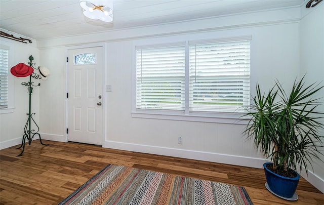 entrance foyer featuring hardwood / wood-style flooring, a wealth of natural light, and ornamental molding