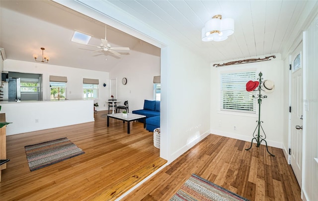 hallway featuring lofted ceiling, hardwood / wood-style floors, a notable chandelier, and wooden ceiling