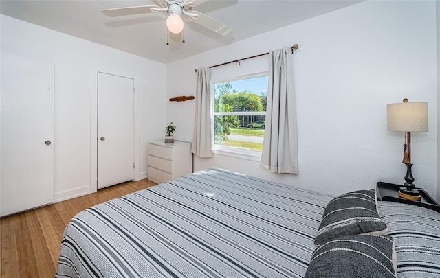 bedroom with ceiling fan and light hardwood / wood-style floors