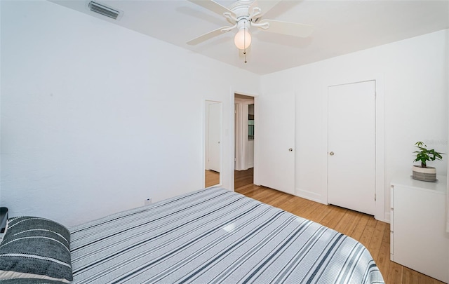 bedroom with ceiling fan, a closet, and light wood-type flooring