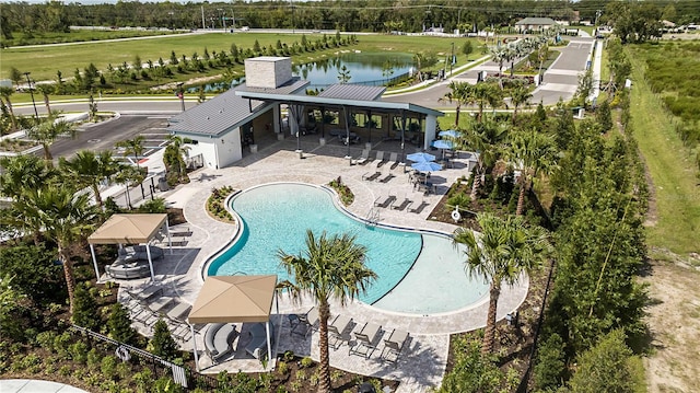 view of pool with a patio area and a water view