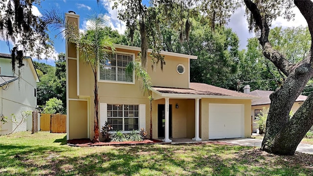 view of front of property featuring a garage and a front lawn