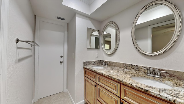 bathroom featuring tile patterned flooring and vanity