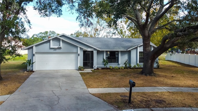 ranch-style house featuring a garage and a front lawn